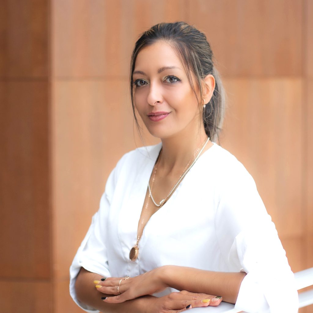 head shot of female wearing white blouse